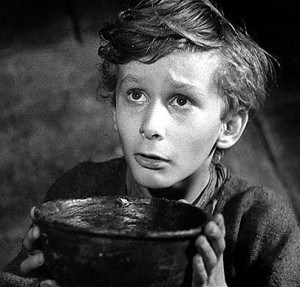 This is a movie still from Oliver Twist of Oliver begging for another bowl of porridge