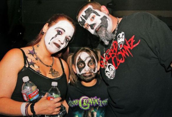 This is a picture of a Juggalo family - mom, dad and daughter - all with their faces painted