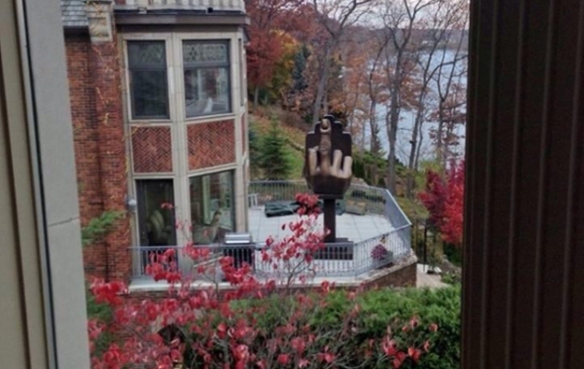 This is a photo of the middle finger statue on the strip club owner's back deck